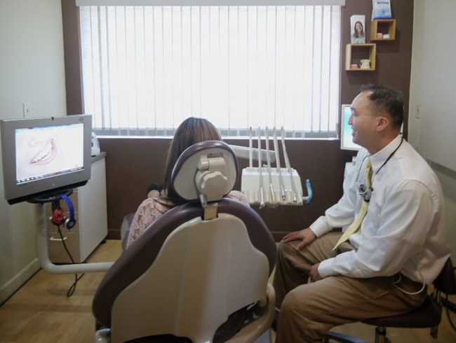 Dr. Shen consulting with dental patient in La Mesa